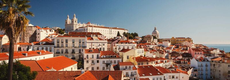 Lisbon (LIS) View of the Alfama district of Lisbon, with the sea in the background