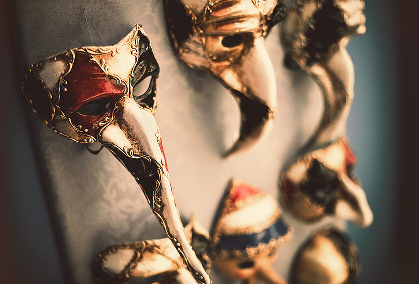 Venetian masks in light gold, red and black colors