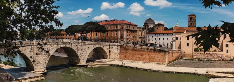 View of a bridge over the Tiber River and the Trastevere in Rome, Italy