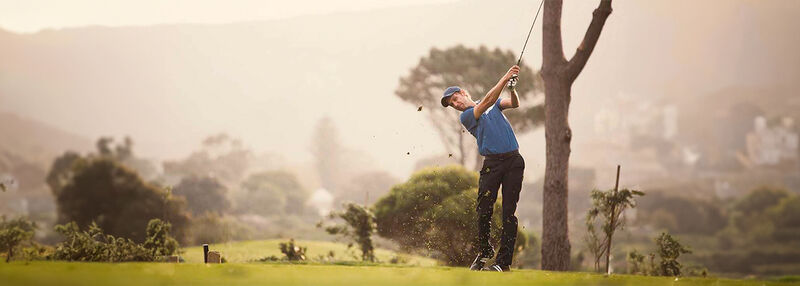 Golf player hitting a golf ball during a game