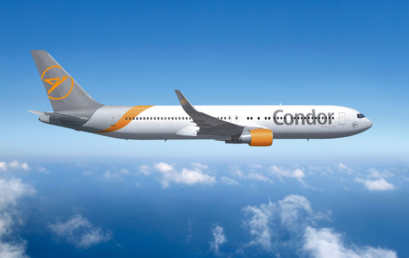 Condor Boeing 767 A Boeing 767 aircraft with Condor branding flies against a blue sky